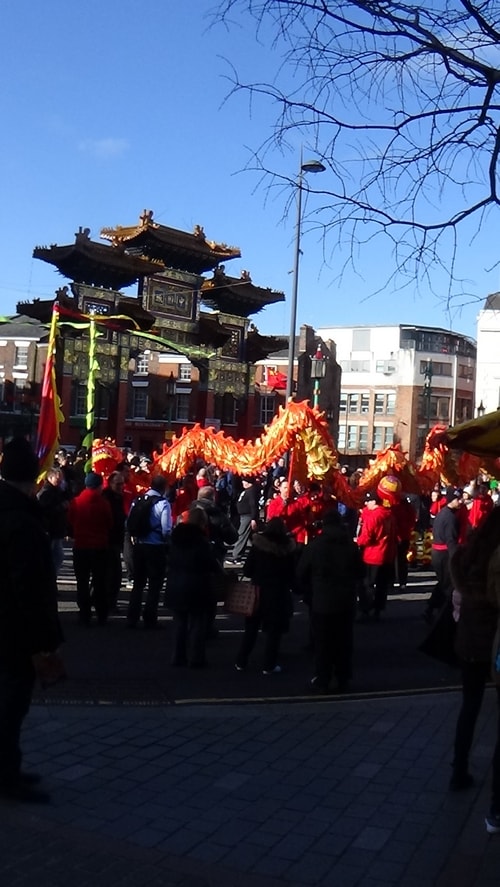 Chinese New Year Liverpool 2016 Chinese dragon with Chinese Arch in background at entrance to Chinatown 7th February 2016