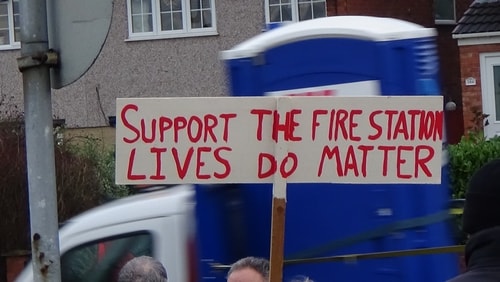photo 20 people waiting for Planning Committee site visit to start Support the Fire Station Lives Do Matter banner 13th December 2016