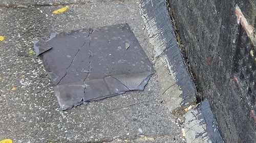 Another roof tile smashes to the ground